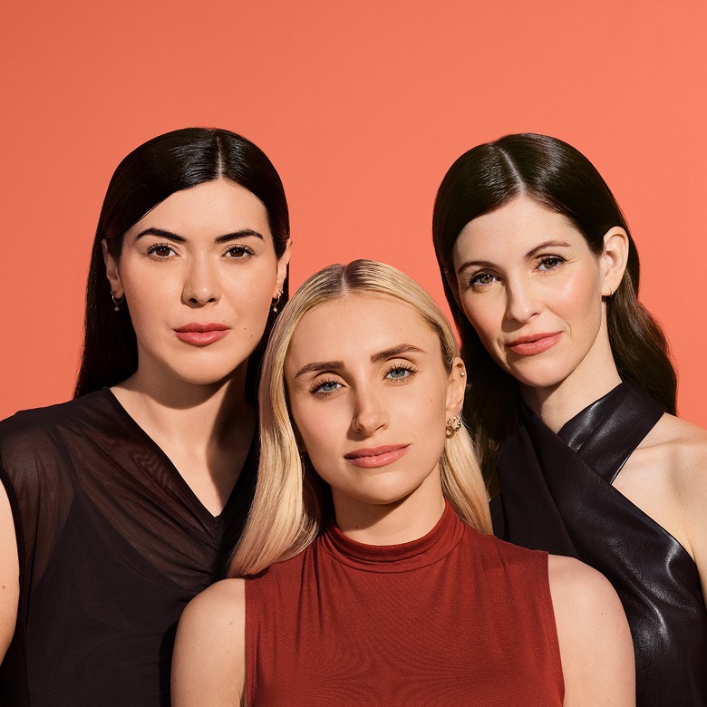 Three women with different skin types smiling