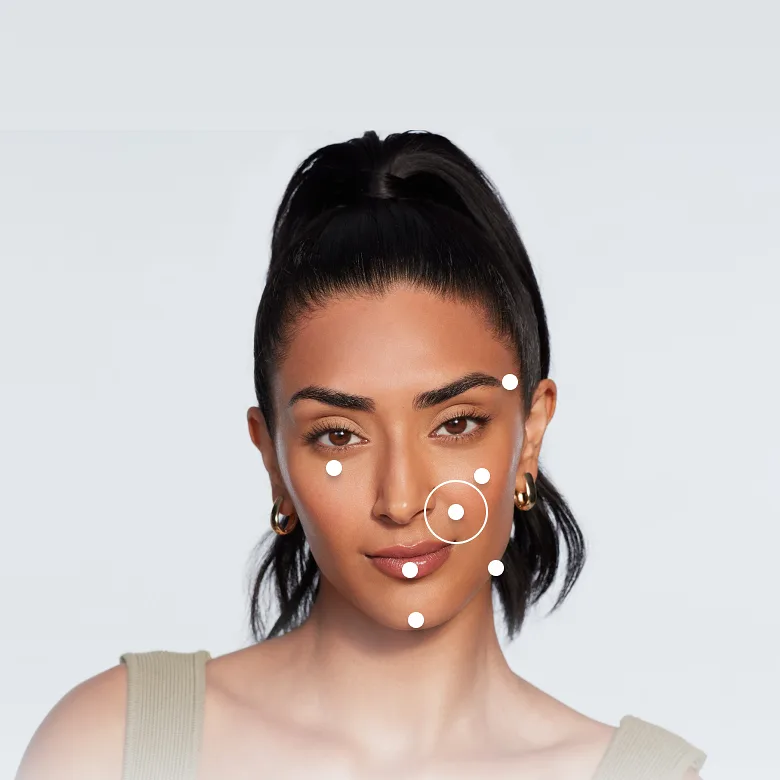 A women looking straight ahead, smiling, with smile lines area highlighted