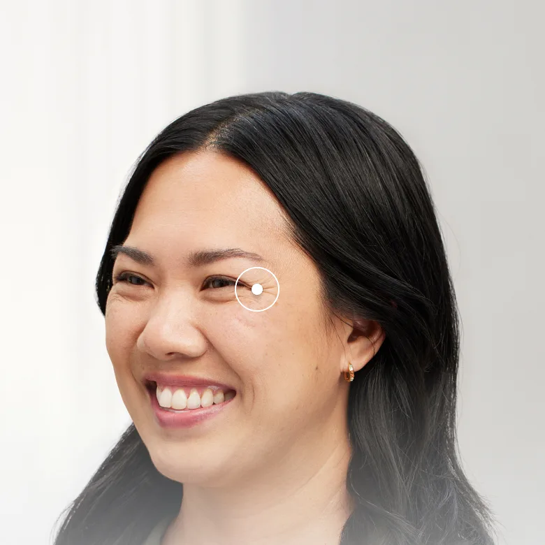 A woman looking to the side showing the wrinkles by her eye